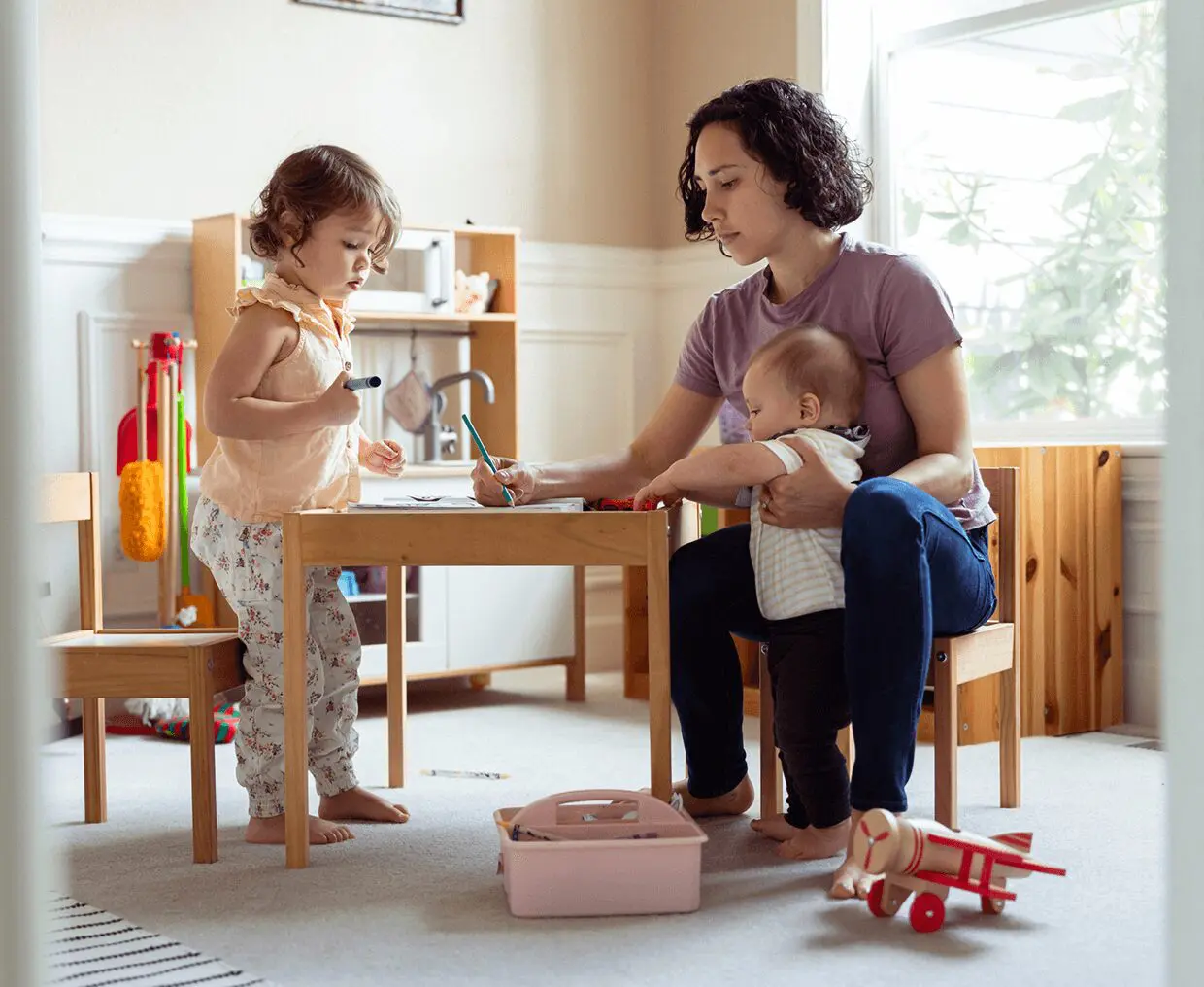 Mother with kids in playroom