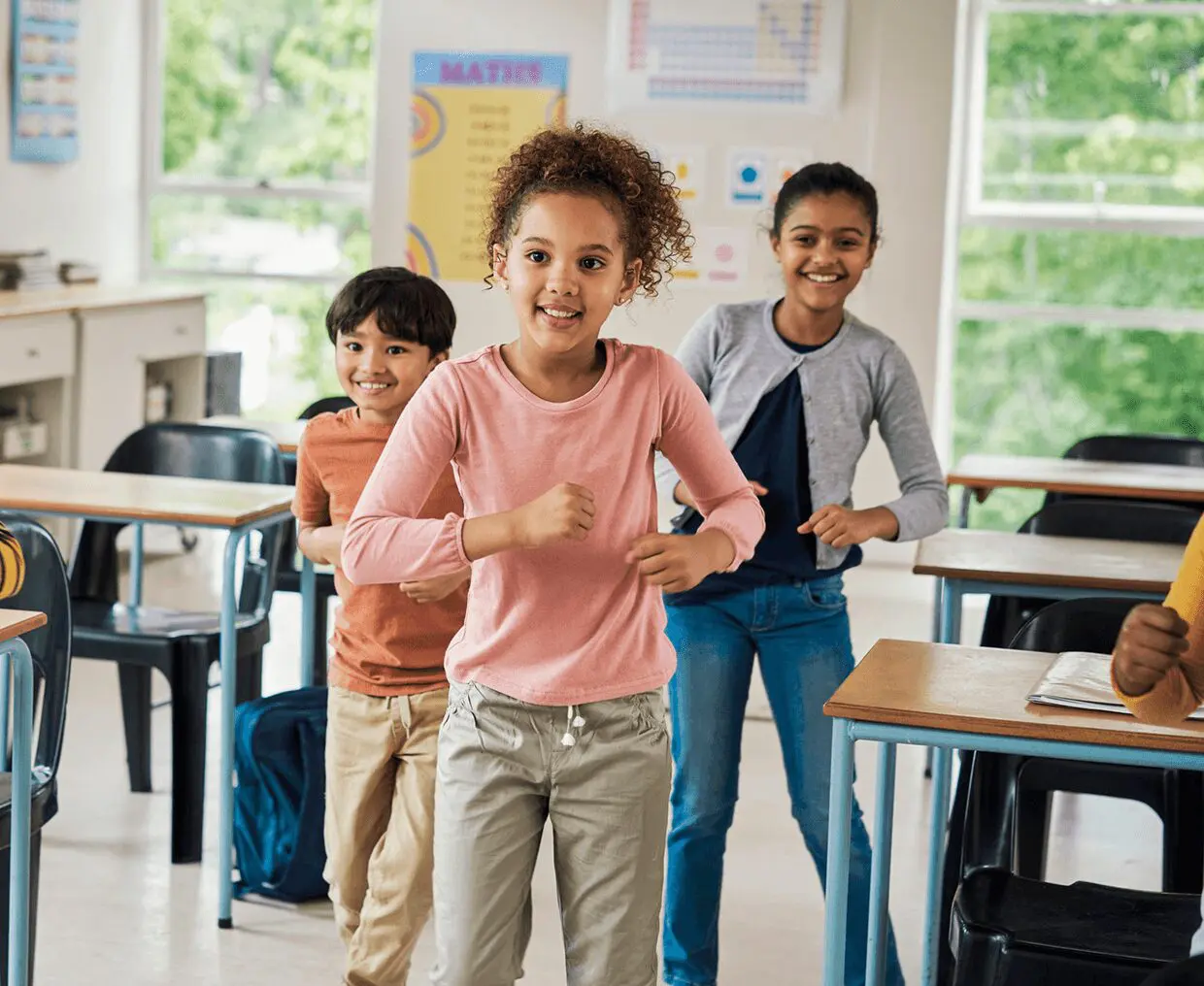 Children smiling and dancing in classroom