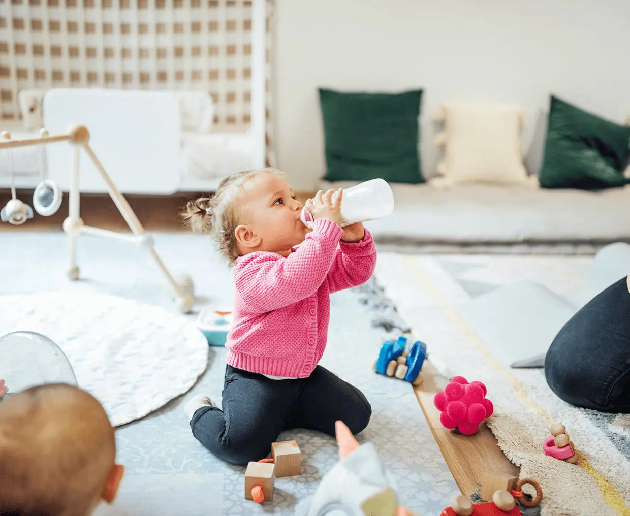 Toddler with toys on floor