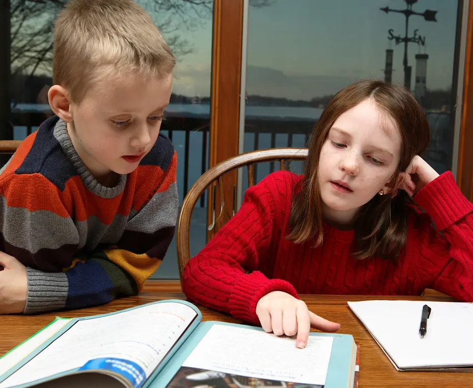 Kids reading a book indoors