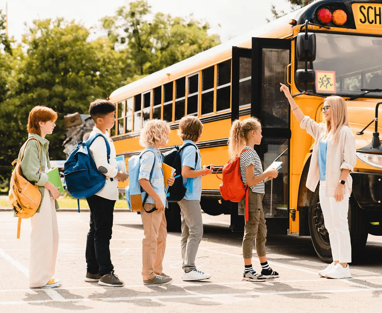 Teacher guiding kids onto school bus