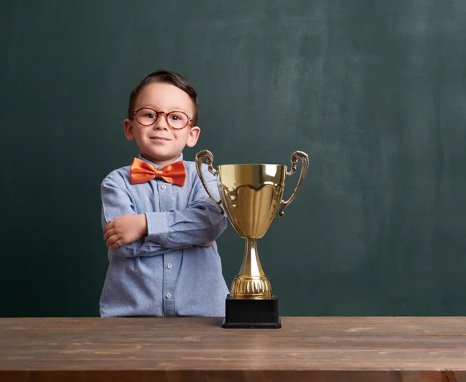 Child with trophy posing confidently