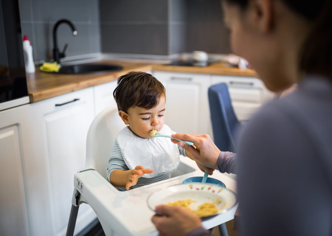 Baby mealtime with spoon and bib