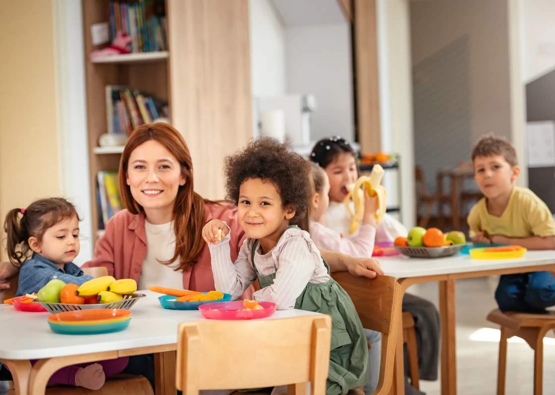 Teacher and children enjoying healthy snacks