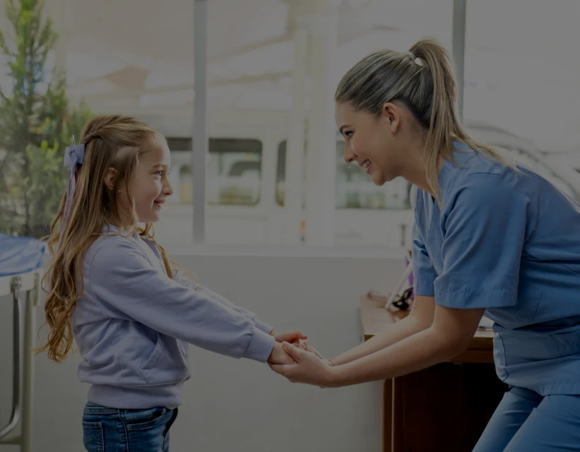 Smiling nurse with young girl